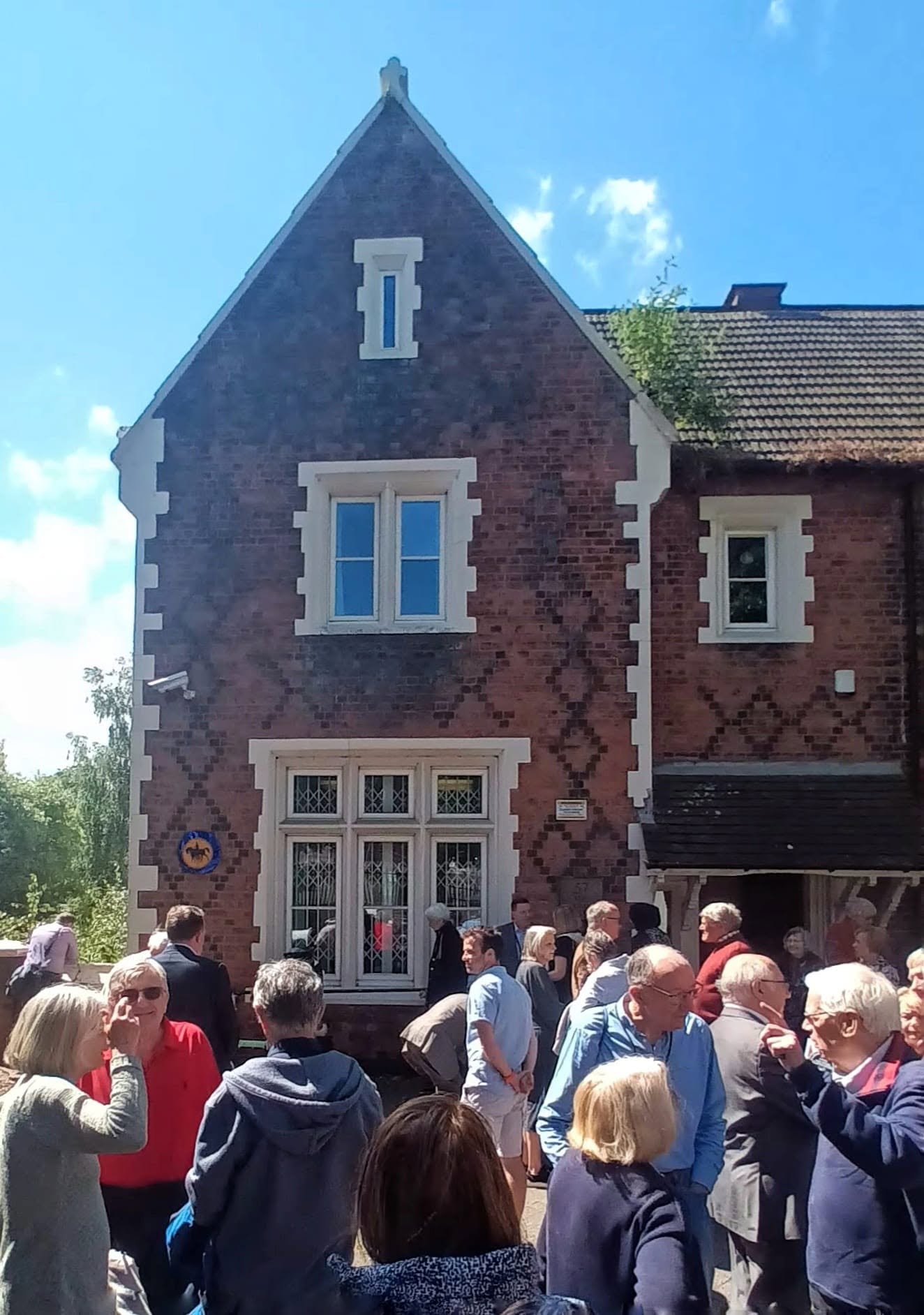 The Old Rectory, home of ConnectFirst Academy, with the community gathered outside